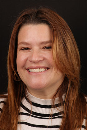 Patient's glowing smile following cosmetic gum contouring and dental veneers.